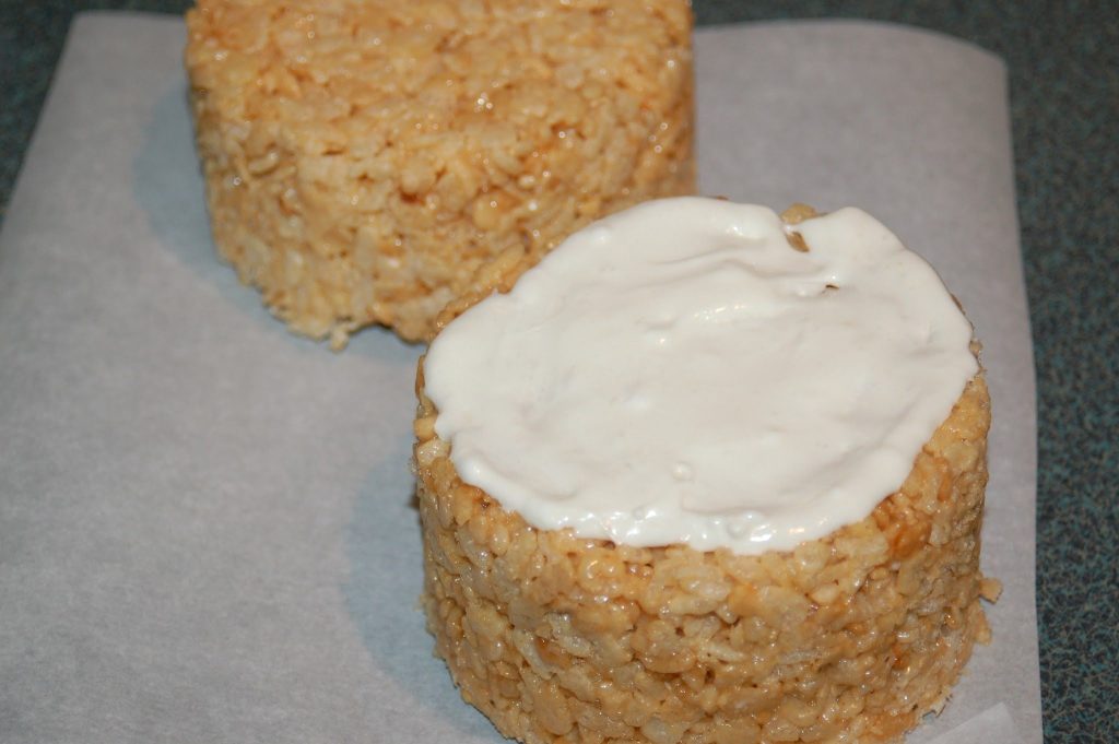 white frosting on crispy cereal peanut butter cake