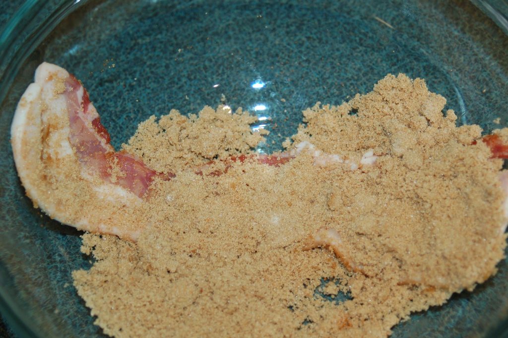 brown sugar mixture on uncooked strip of bacon