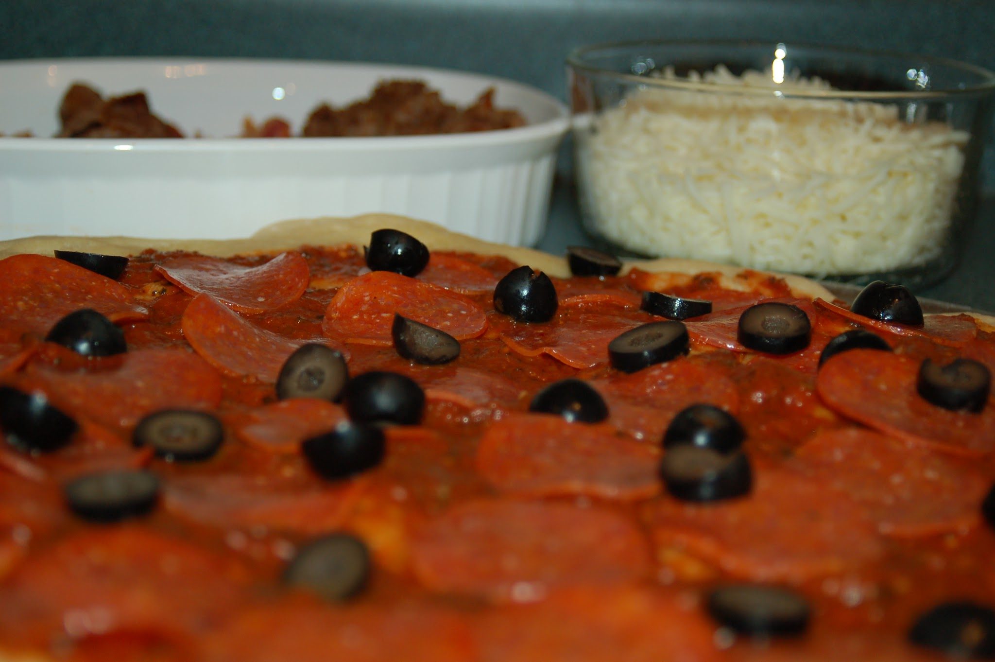 pepperoni pizza with black olives, close up