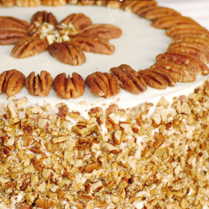 decorated carrot cake with toasted pecans