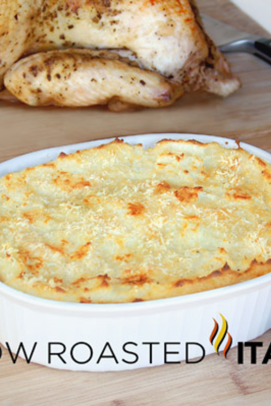 baked parmesan mashed potatoes in white dish.