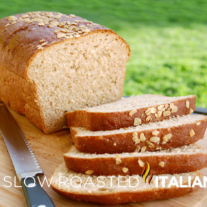 honey wheat oatmeal bread sliced on cutting board