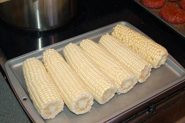 uncooked corn on the cob on tray