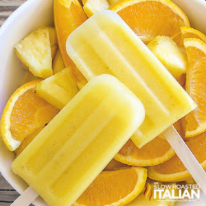 pineapple orange popsicles in bowl of oranges