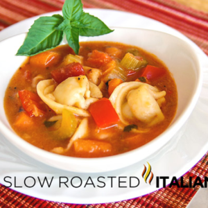 tortellini and vegetable soup in a white bowl