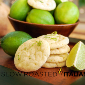 lime coconut sugar cookies stacked on a bread board