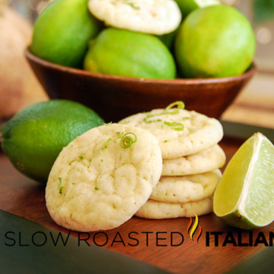 lime in the coconut sugar cookies stacked on a bread board