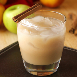 nutty apple cocktail over ice with cinnamon stick