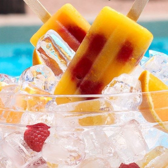 orange raspberry amaretto ice pops in a glass