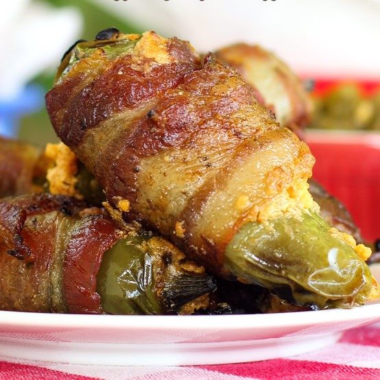 grilled jalapeno poppers wrapped in bacon on a plate