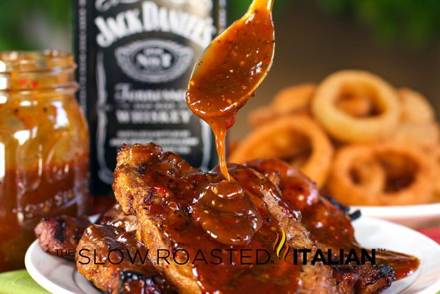 pouring bbq sauce on jack daniels pork chops