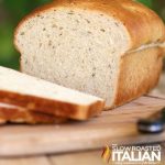 loaf of bread sliced on a cutting board.