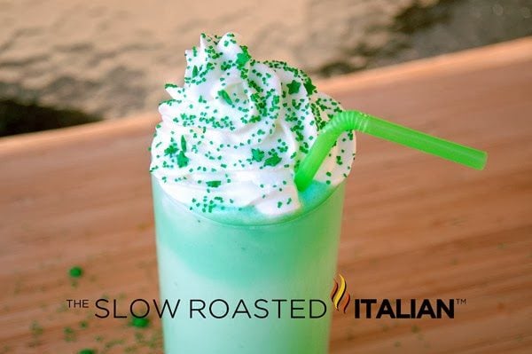 mcdonald's shamrock shake in tall glass with whipped cream, green sugar sprinkles and green straw- copycat recipe
