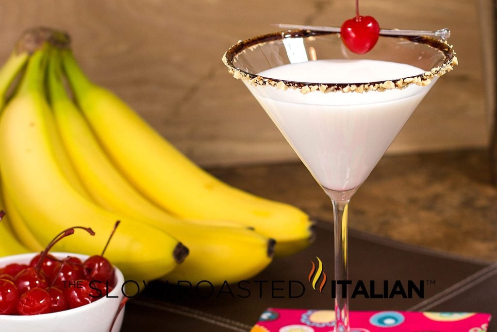 banana split martini in a glass with cherry on top