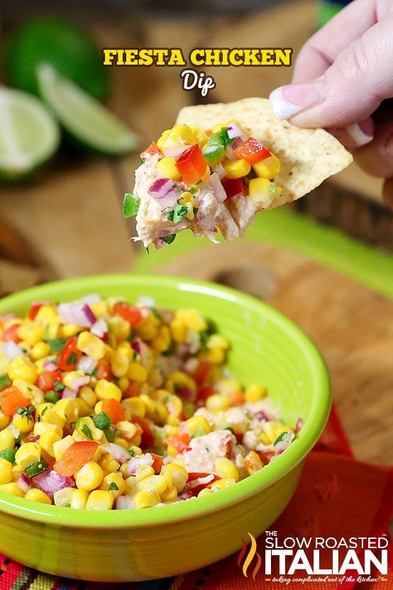 Fiesta Chicken Dip is a simple layered dip featuring creamy salsa chicken that is topped with a fresh corn salsa. It is bursting with flavor and this recipe is so easy to put together. This scoopable party dip is sure to be the star of the show. A great way to use up left over chicken!