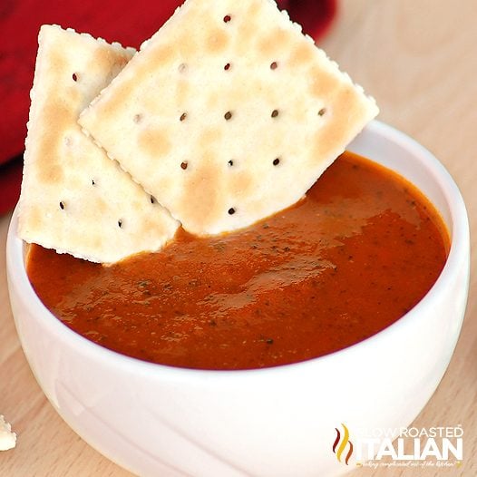 bowl of roasted tomato basil soup with two crackers