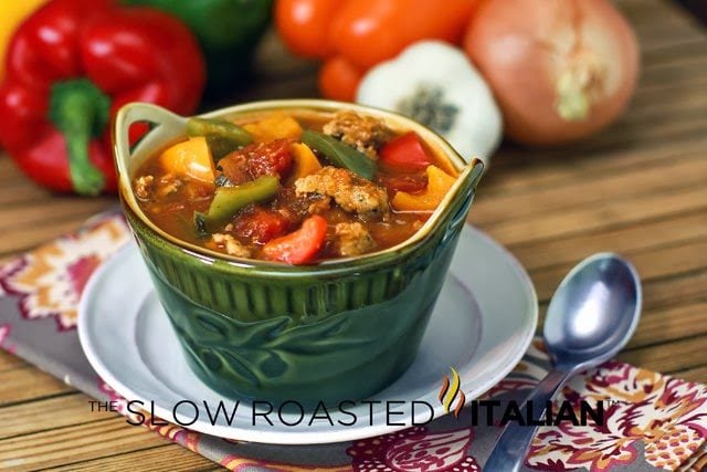 sausage and pepper soup in green bowl