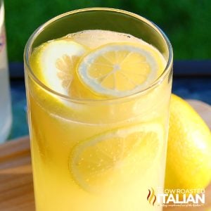 lemonade cocktail in tall glass with lemon slices