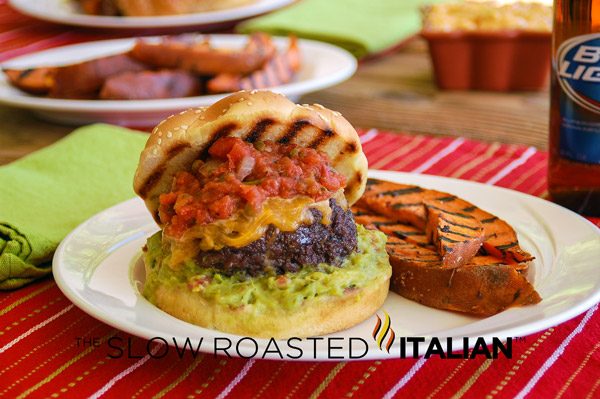 gourmet burger stuffed with spicy cheese, topped with salsa and guacamole