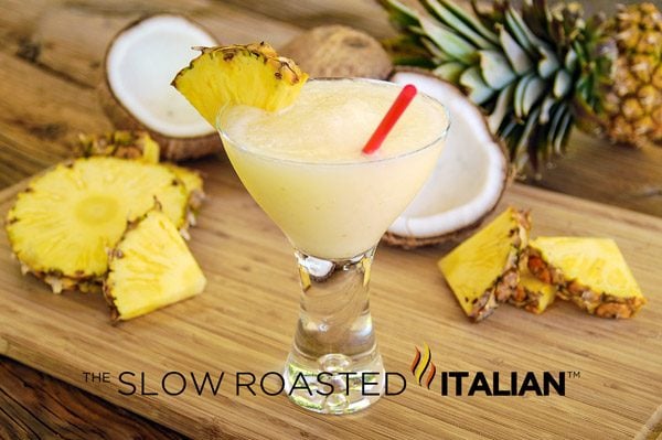 perfect pina colada in glass with pineapple garnish on rim