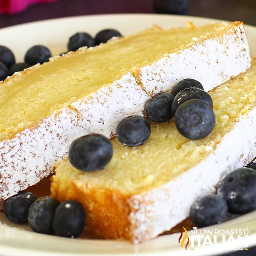 lemon loaf slices with powdered sugar and blueberries on top
