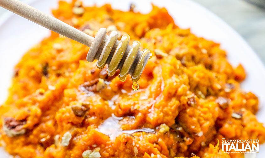 dripping honey from dripper onto a sweet potato side dish.