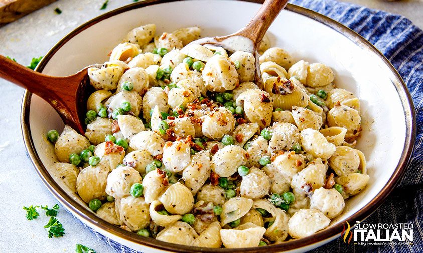 mixing bacon pea pasta salad