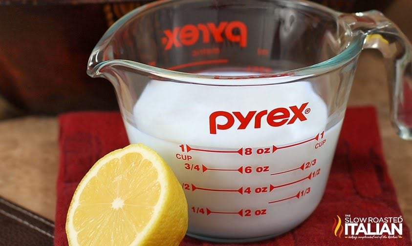 lemon next to glass measuring cup of milk