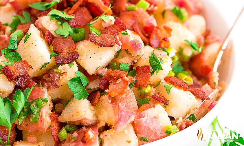 german potato salad in white bowl