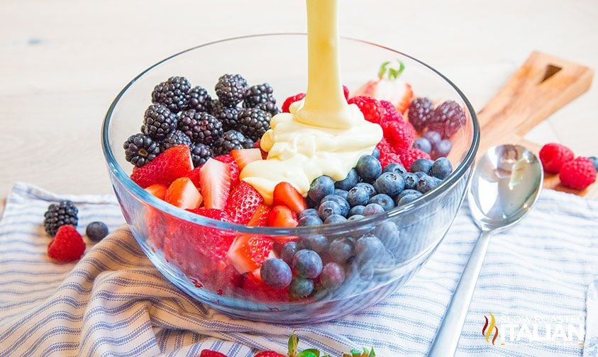 adding cheesecake to fresh fruit