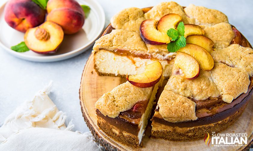 peach cobbler cheesecake cut into slices