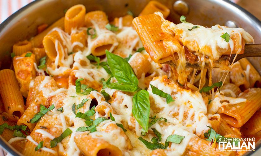 breaded chicken cutlet with cheesy pasta on fork