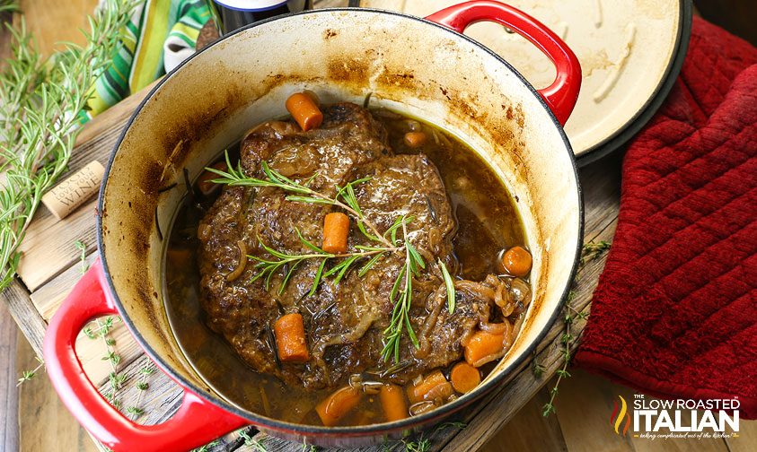 cooking roast in a pan with carrots