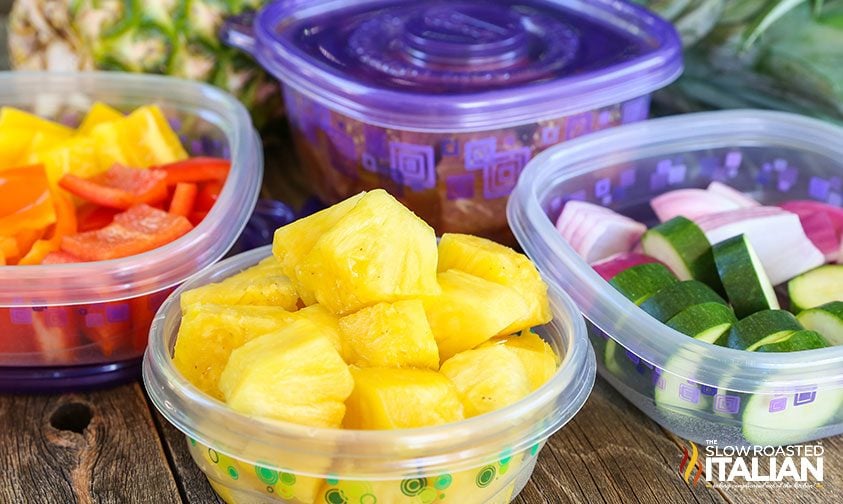 storage containers with chunks of pineapple and vegetables