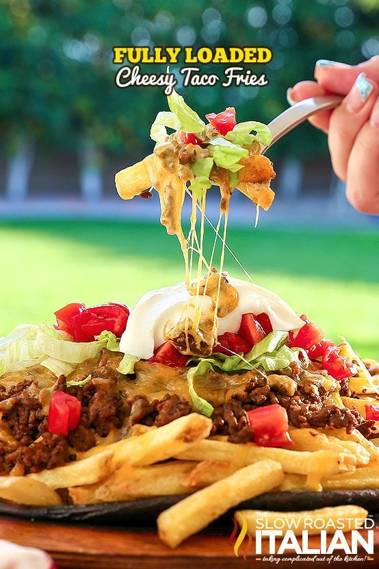 fully loaded cheesy taco fries on a fork