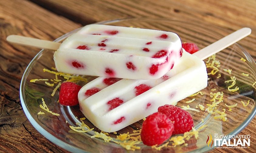 raspberry lemonade popsicles stacked on a a plate