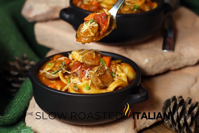 hearty italian sausage soup in black bowl