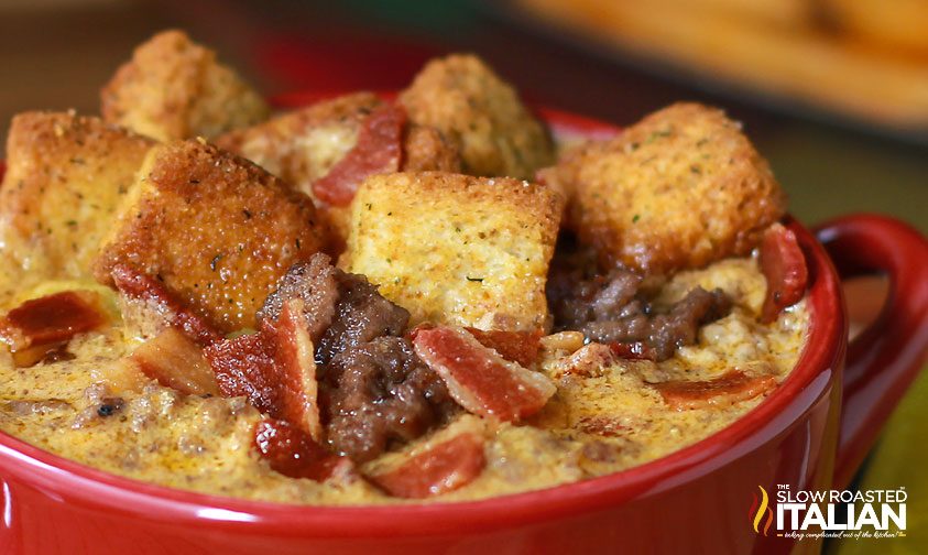 cheesy soup in bowl with crispy bacon and croutons