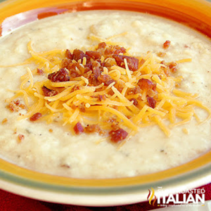baked potato soup in a bowl with grated cheese