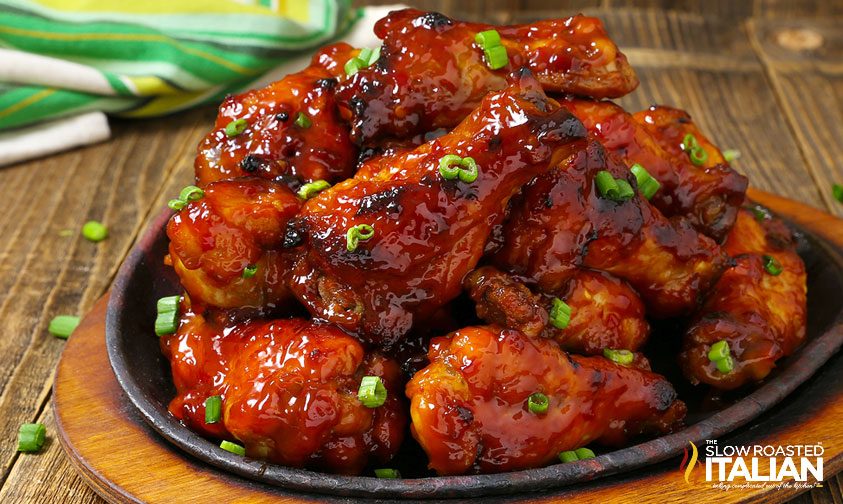 slow cooker sweet and spicy barbecue wings on a black plate