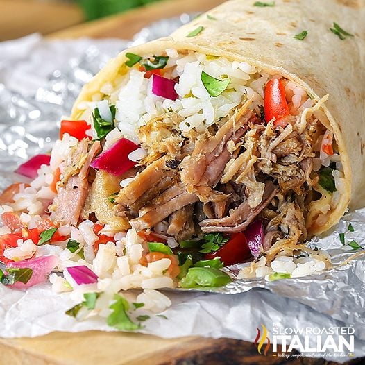 slow cooker carnitas wrapped in flour tortilla