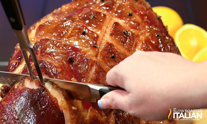 slicing orange honey glazed ham