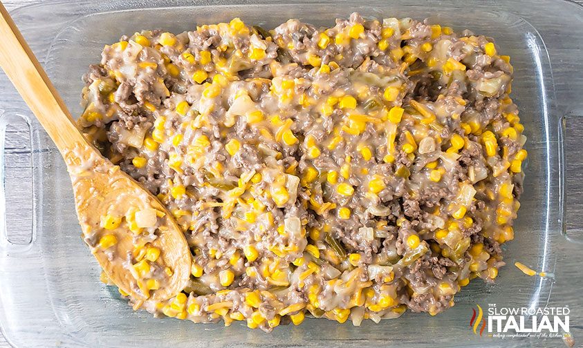 layering tater tot casserole in baking dish