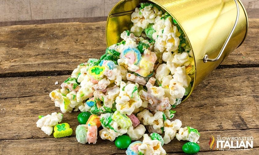 leprechaun popcorn sweet snack mix spilling out of small gold bucket