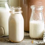 white beverage in glass bottles