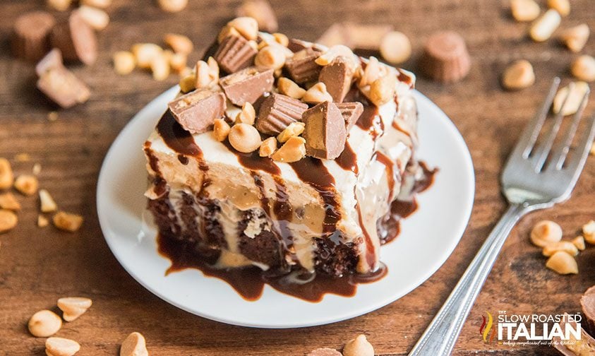 piece of chocolate peanut butter poke cake on white plate