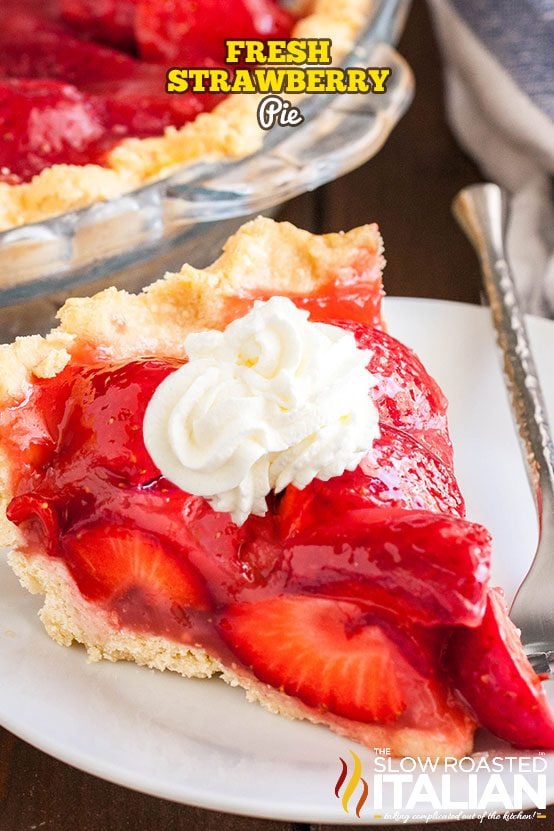 slice of fresh strawberry pie on white plate with fork