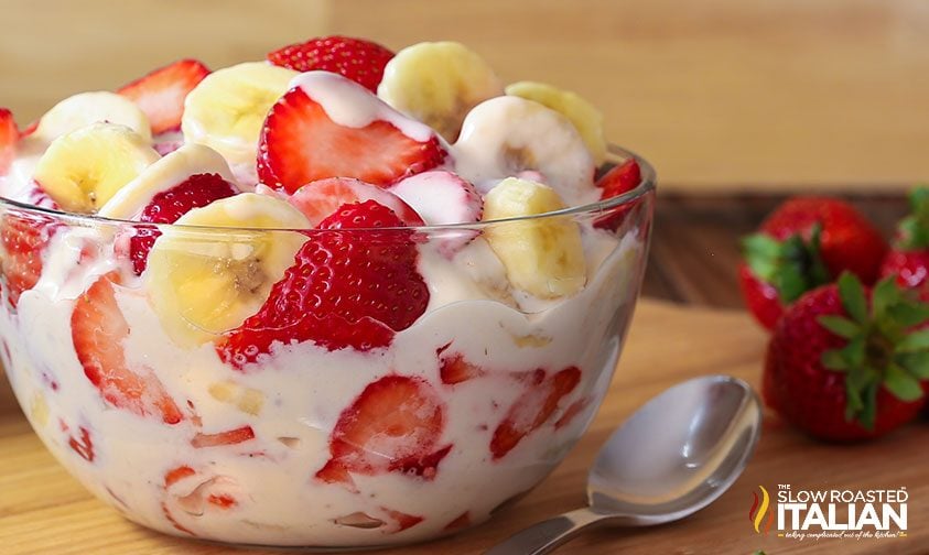 strawberry banana cheesecake salad in bowl with spoon