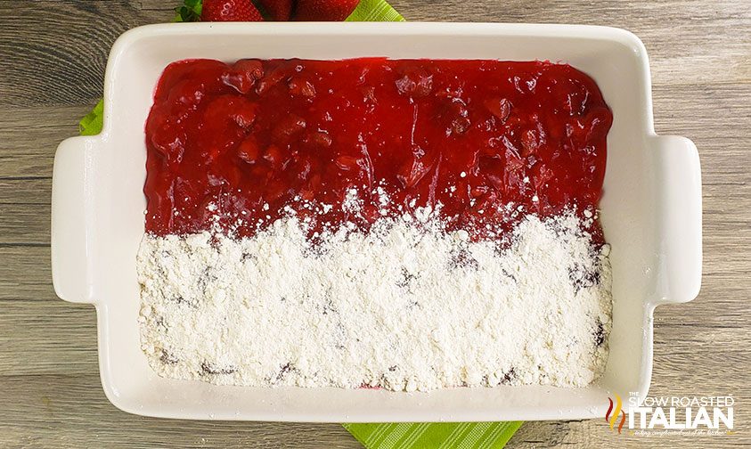 strawberry pie filling and cake mix in baking dish