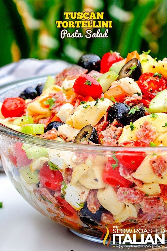 titled (shown in salad bowl) Tuscan tortellini pasta salad